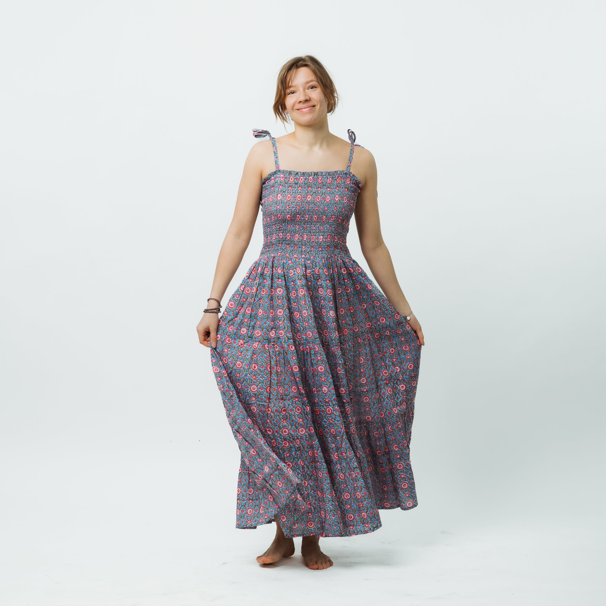 Woman wearing a patterned dress on a white background