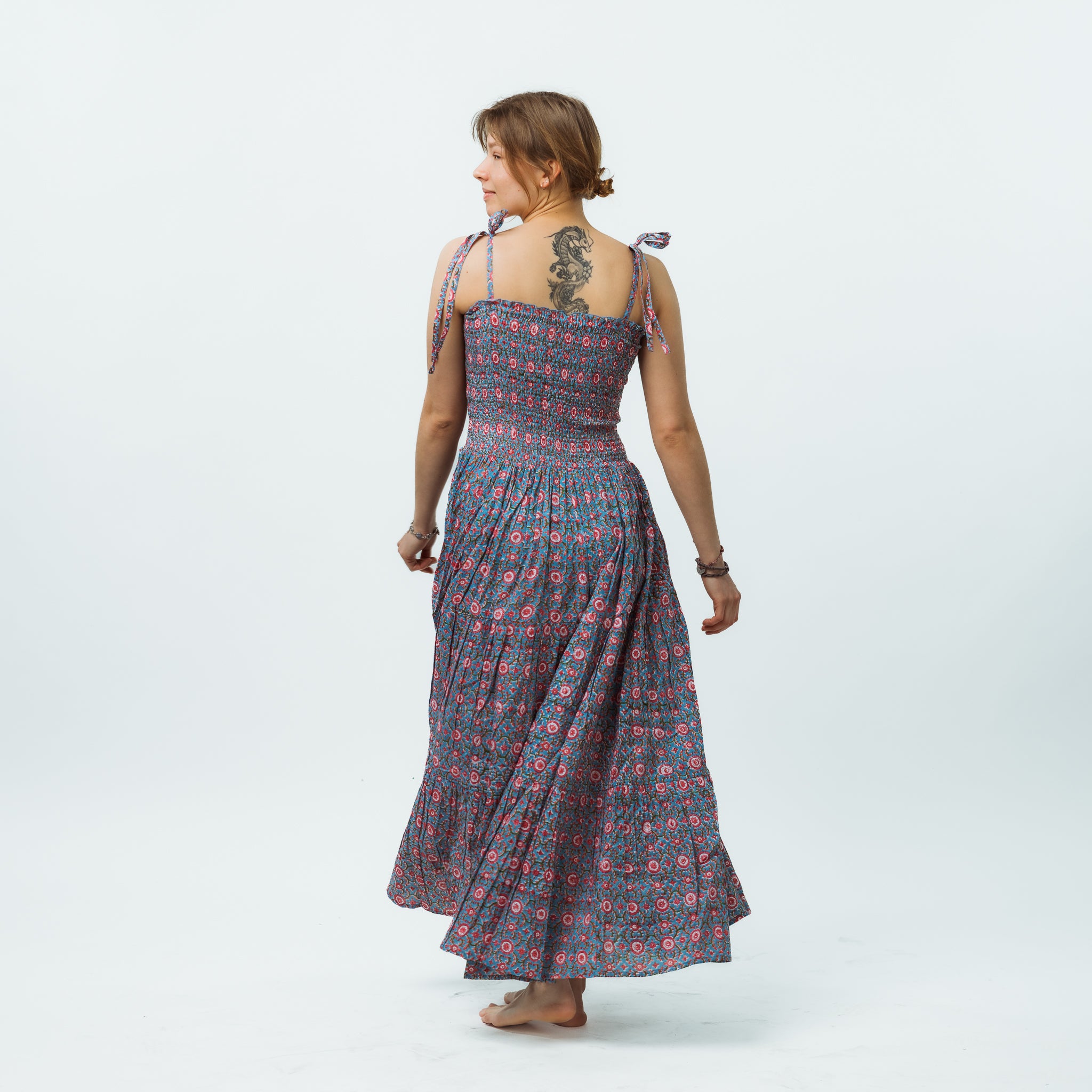Woman wearing a patterned dress on a white background