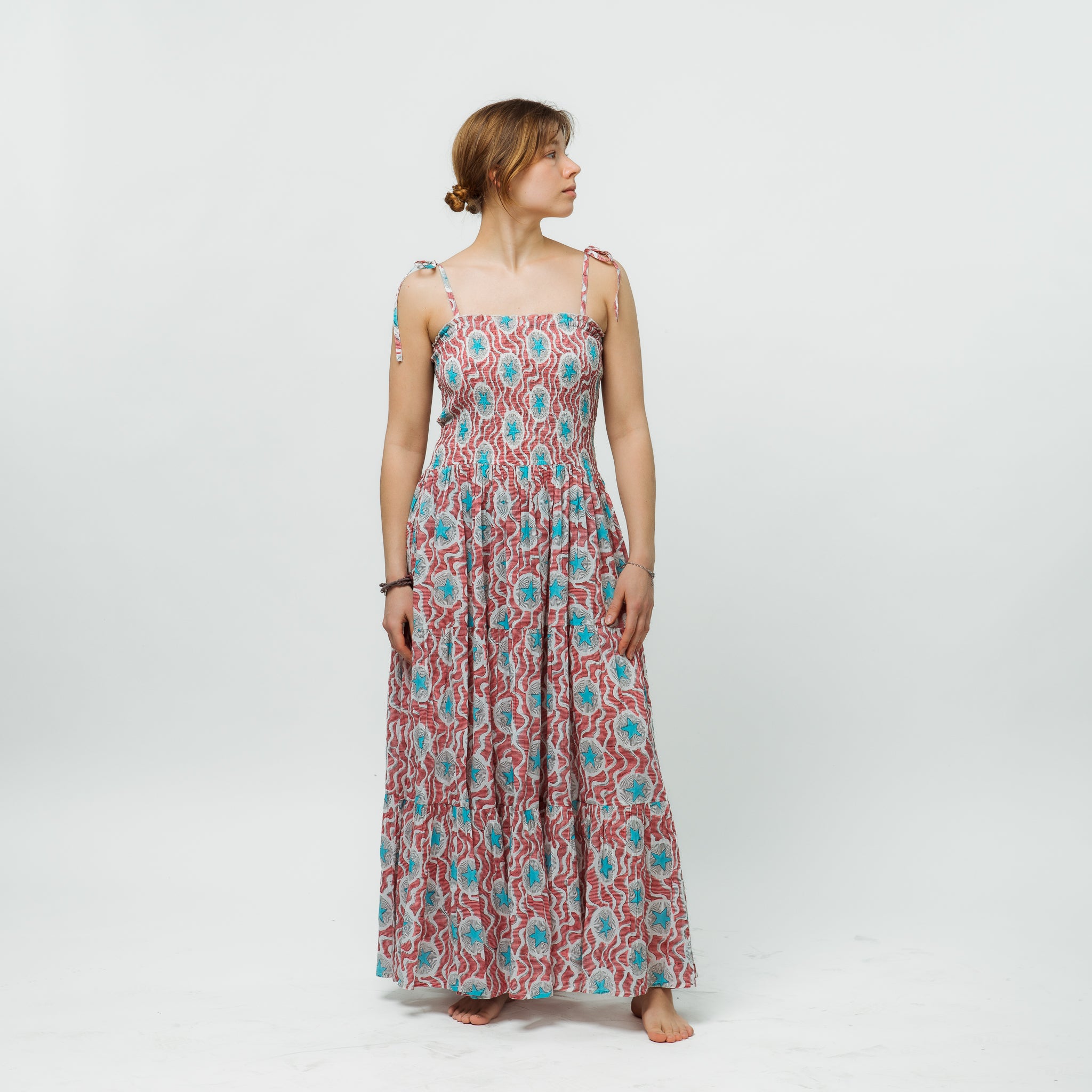 Woman wearing a floral patterned dress on a white background