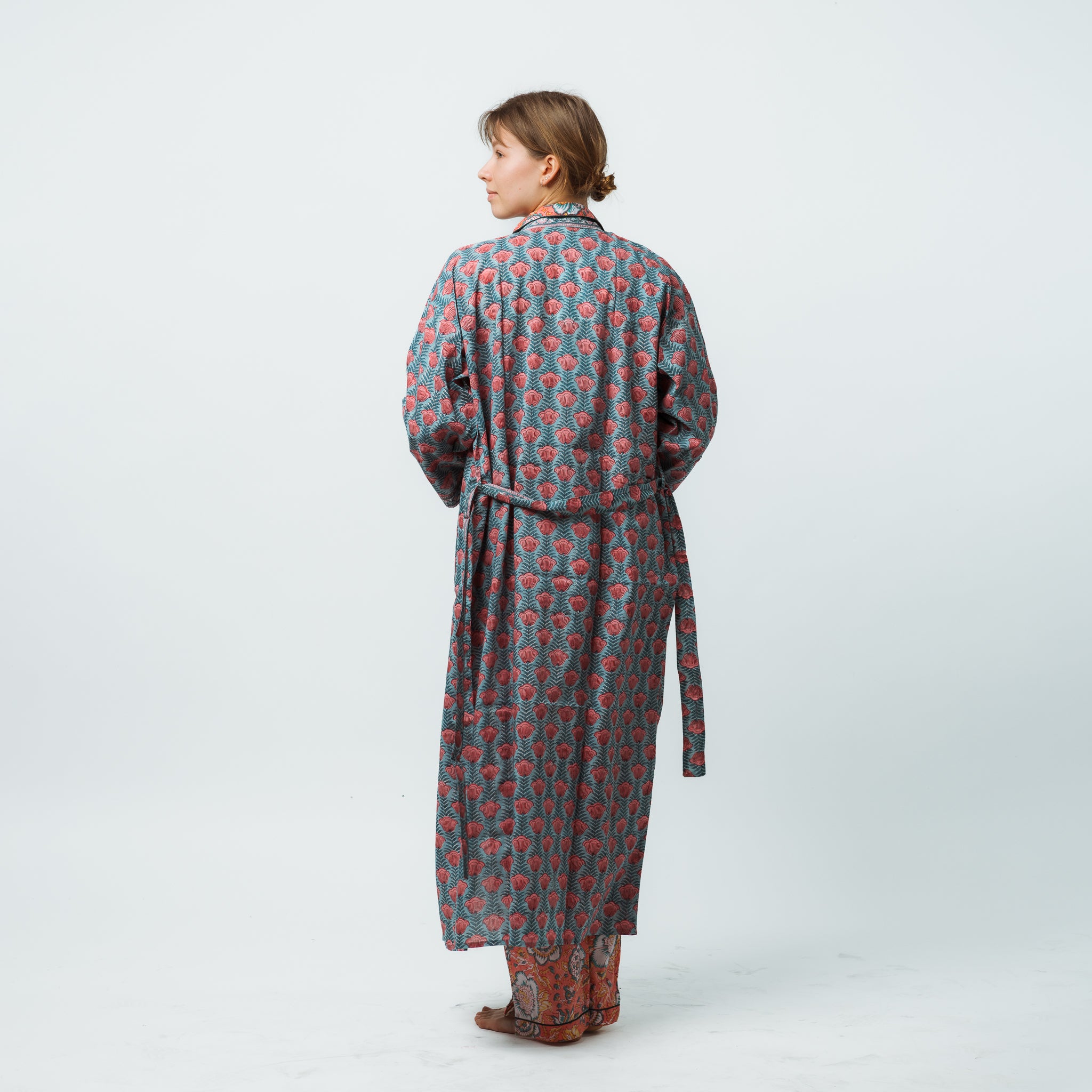 Woman wearing a patterned robe on a white background