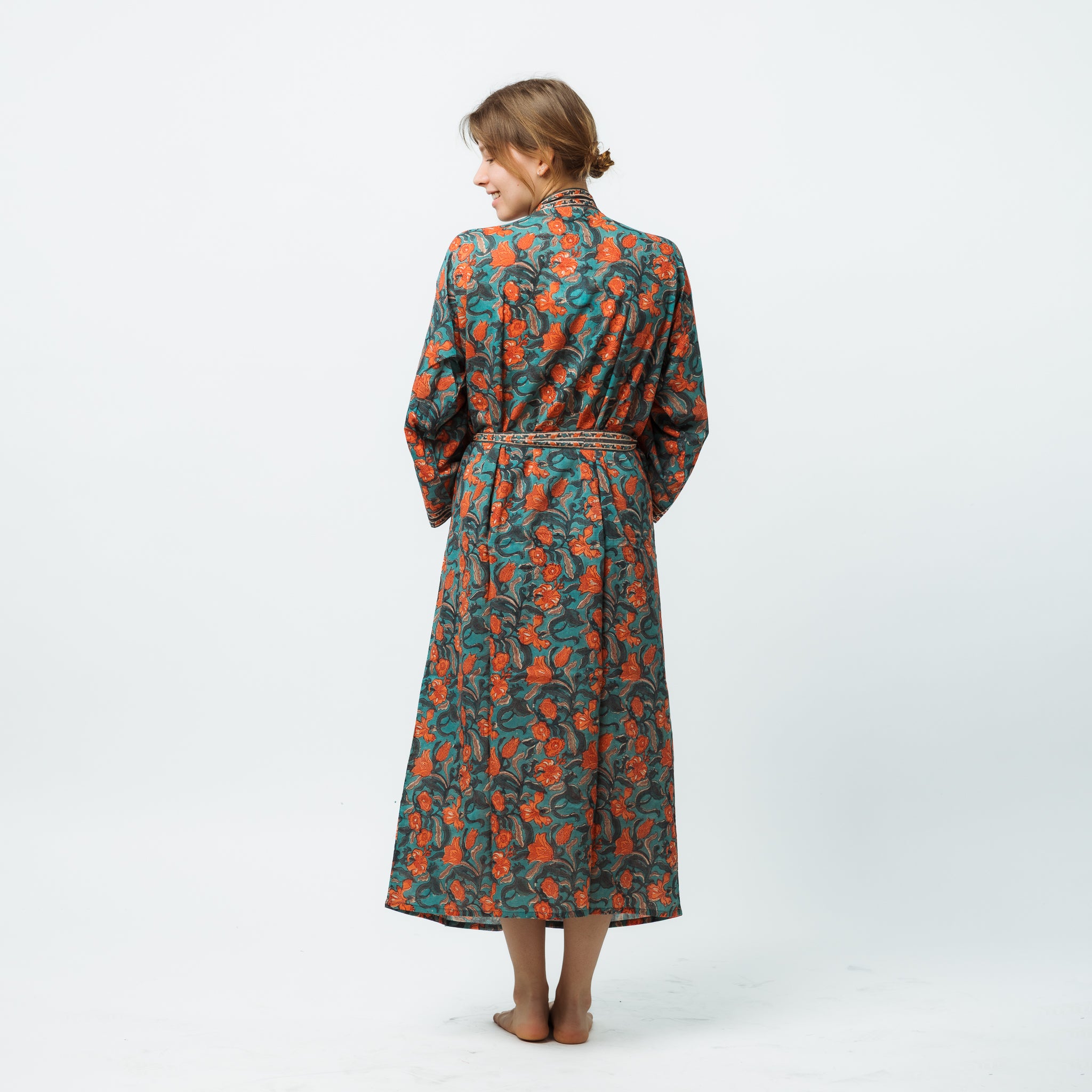 Woman wearing a floral patterned dress on a white background