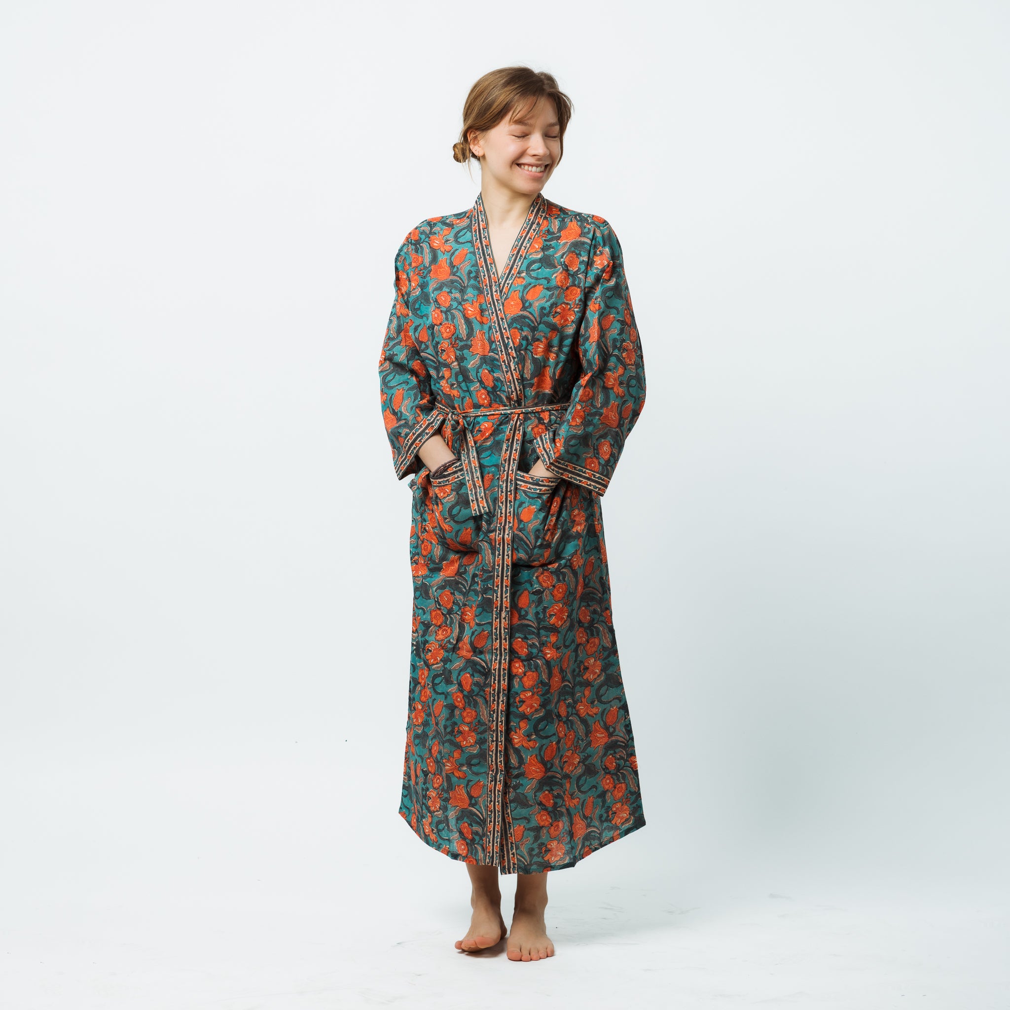 Person wearing a patterned robe on a white background