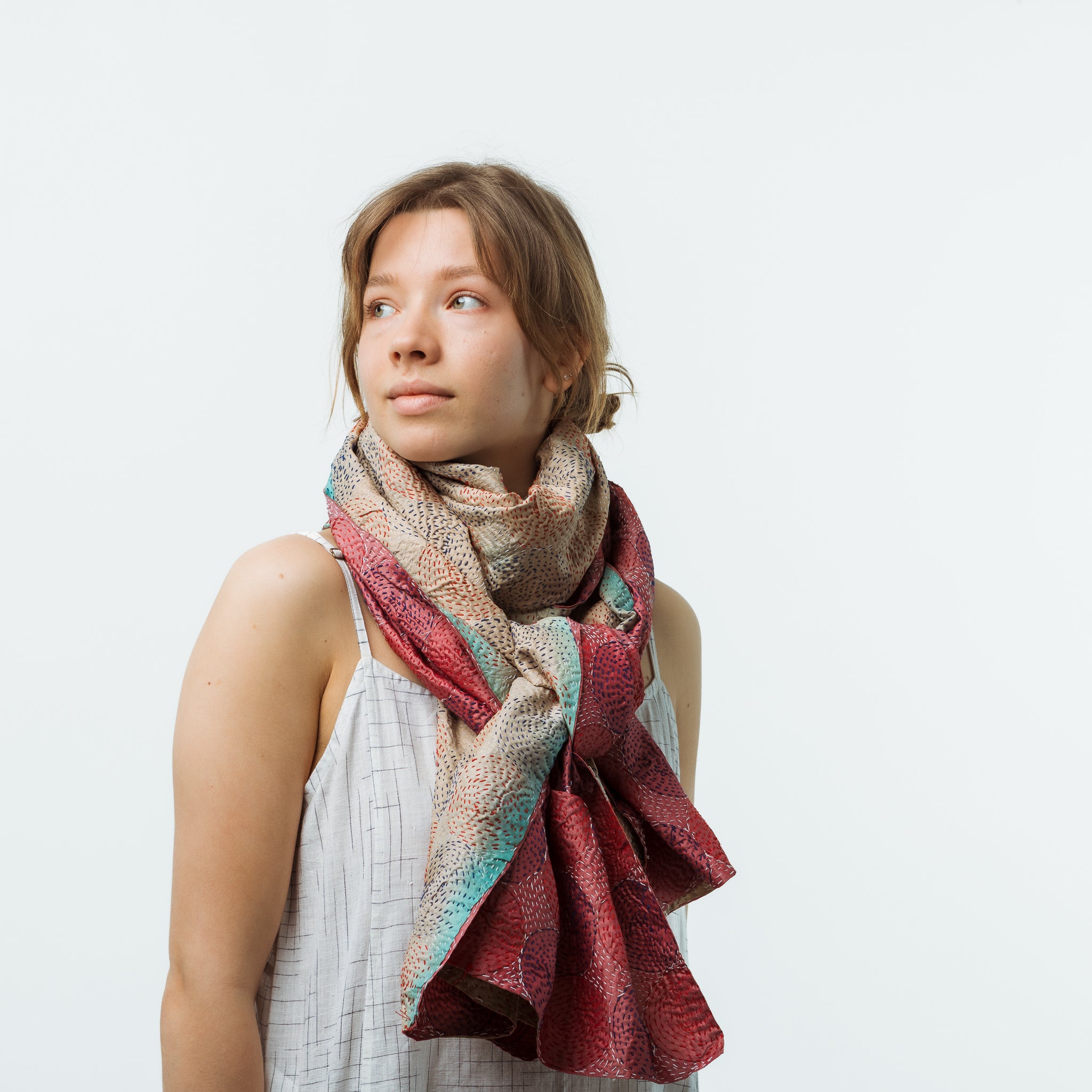 Woman wearing a colorful scarf on a white background