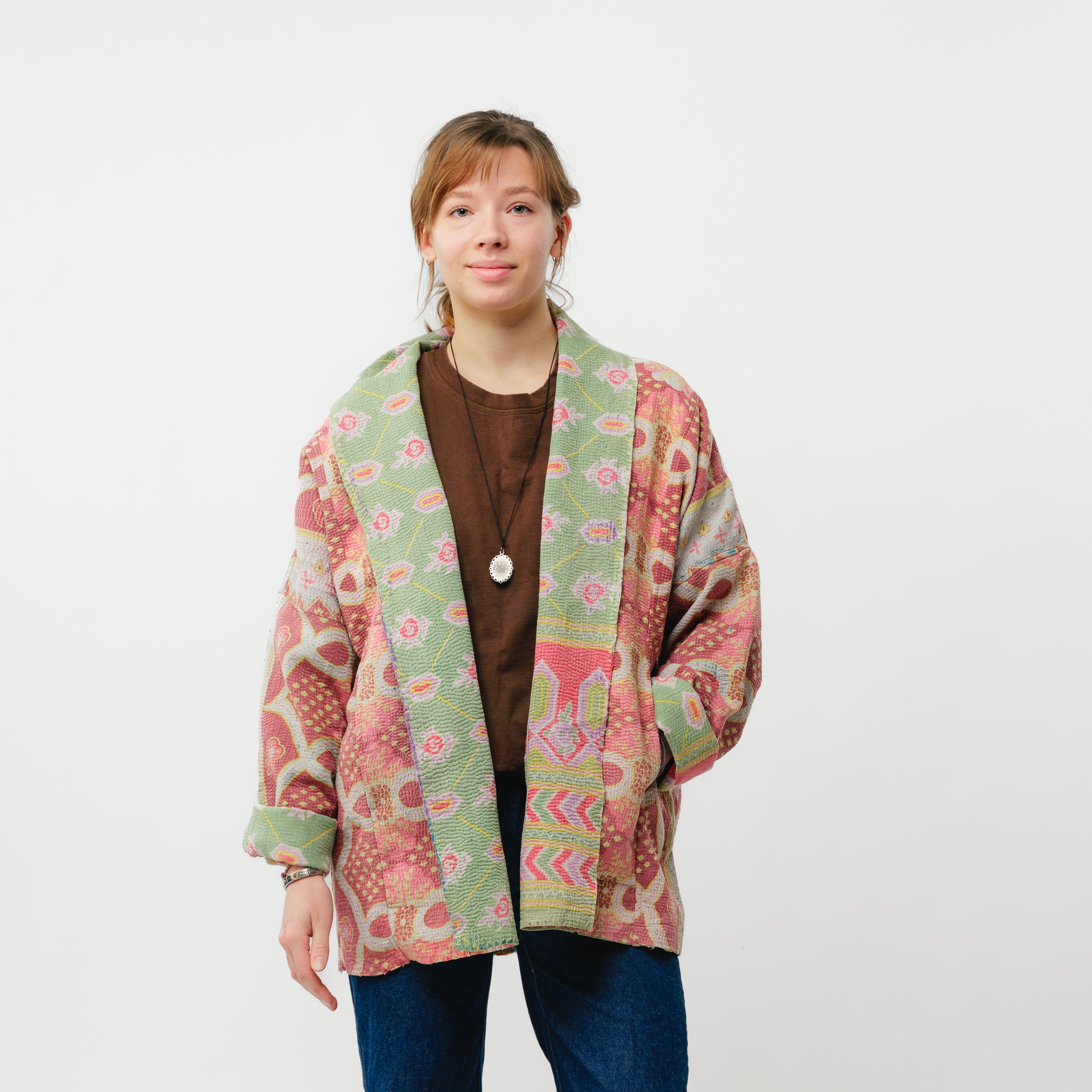 Person wearing a colorful patterned jacket on a white background