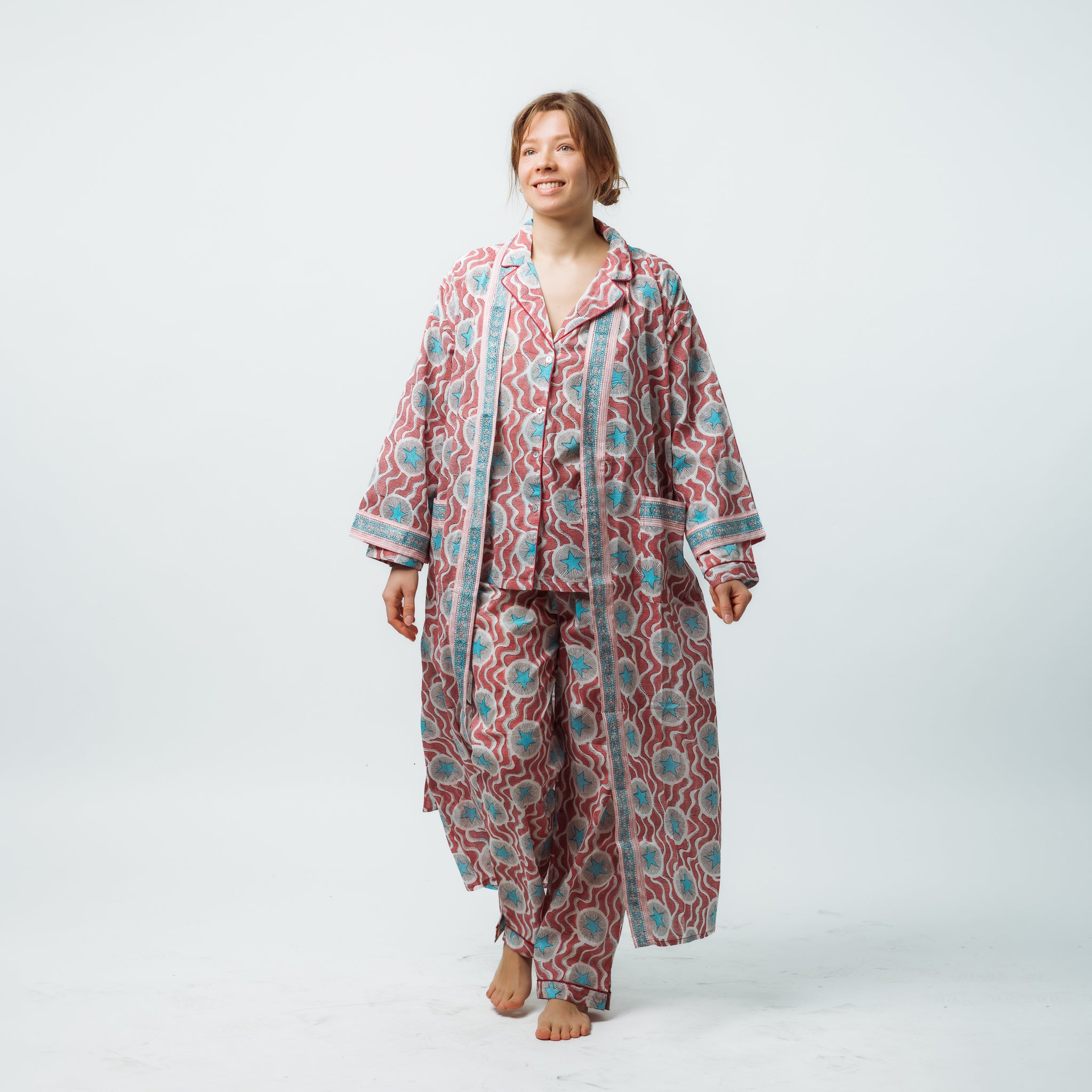 Person wearing a patterned pajama set on a white background
