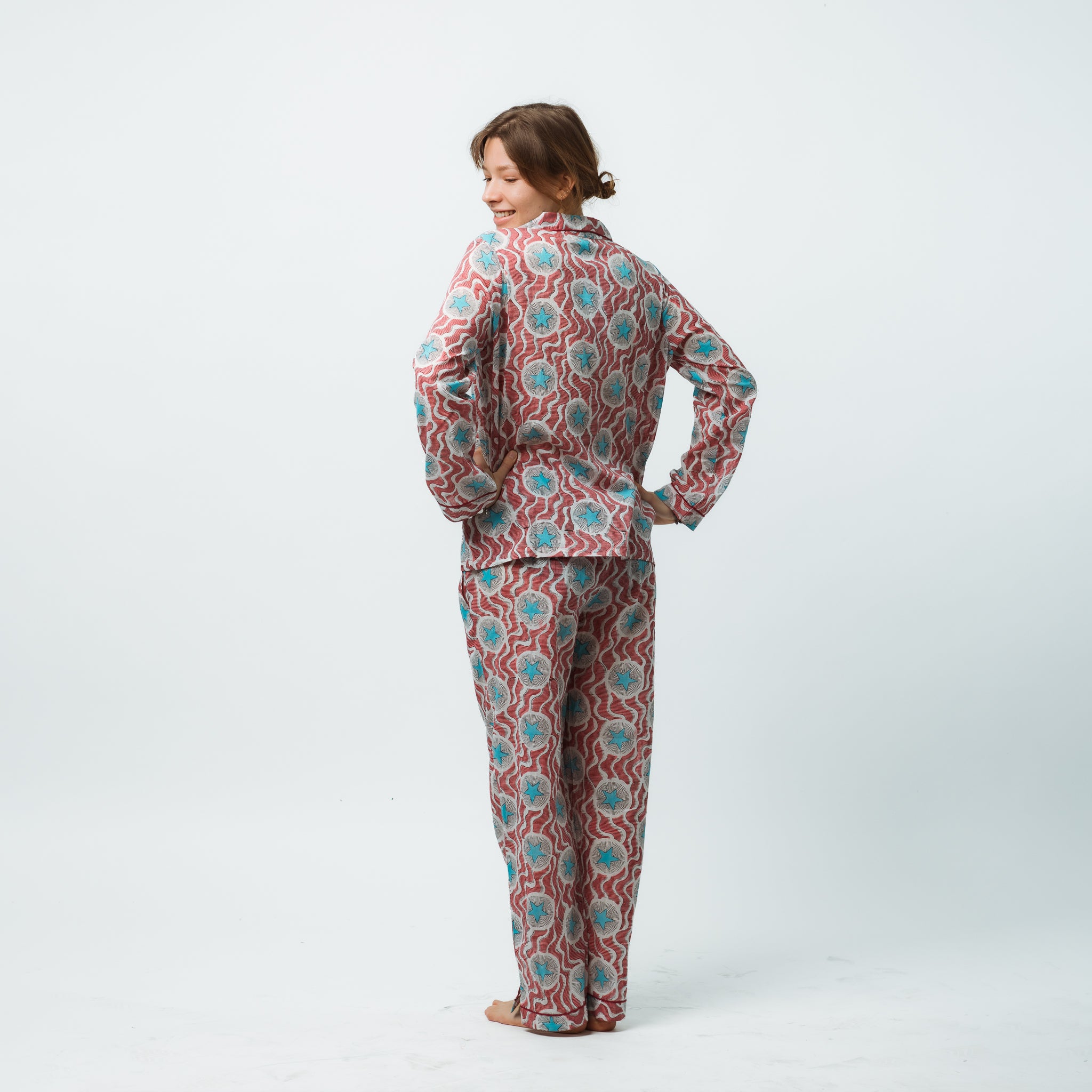 Woman wearing a patterned pajama set on a white background
