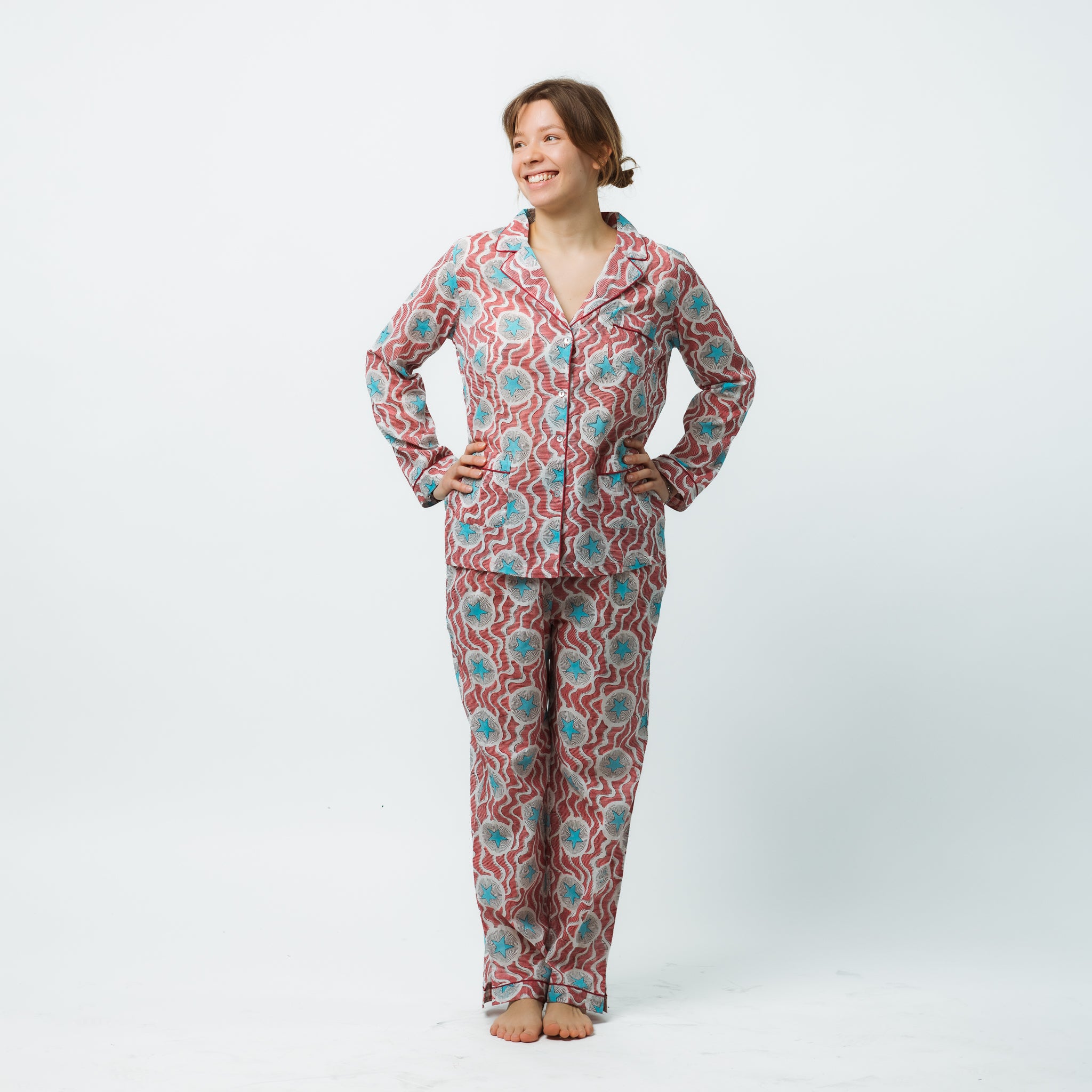 Person wearing a patterned pajama set on a white background