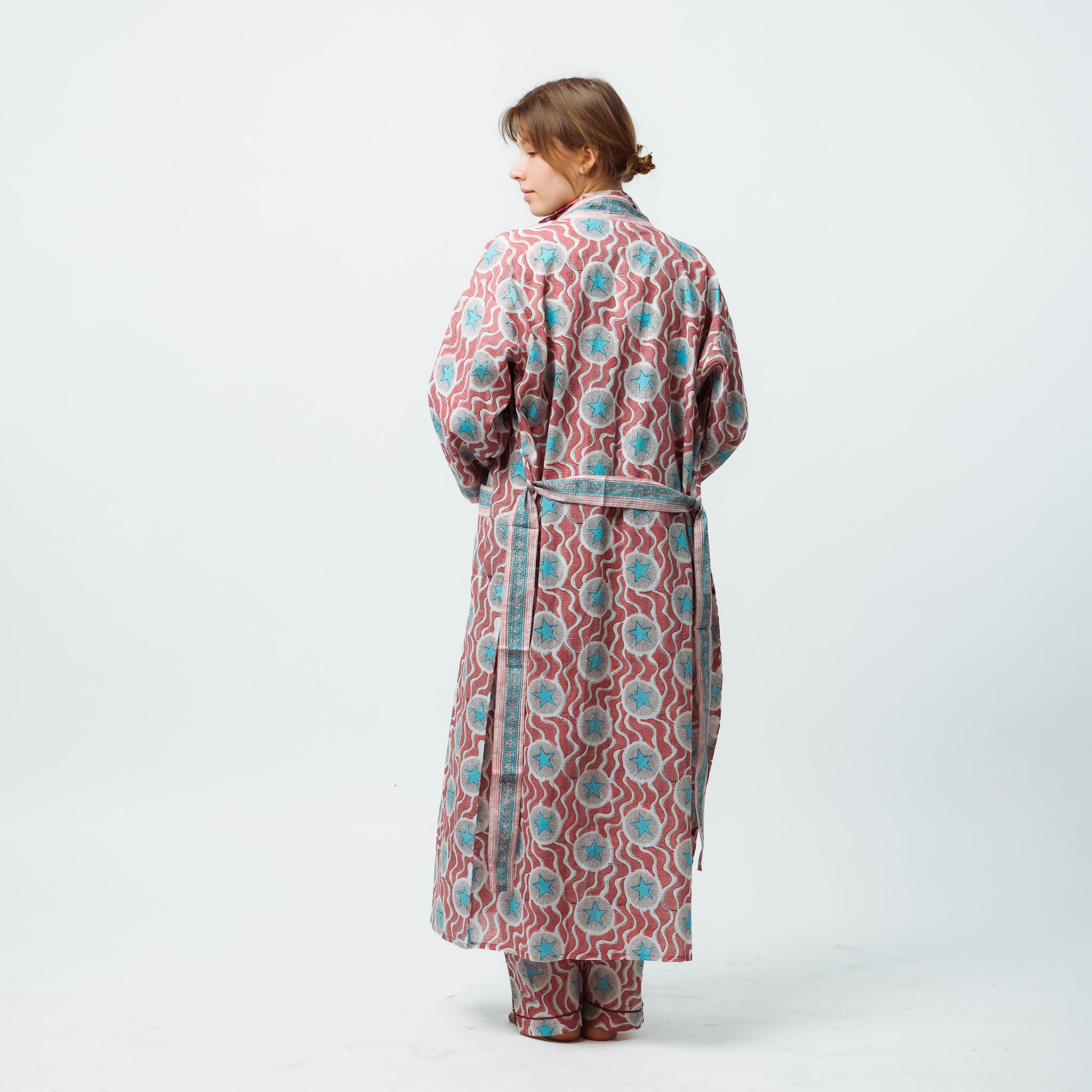 Woman wearing a patterned robe on a white background