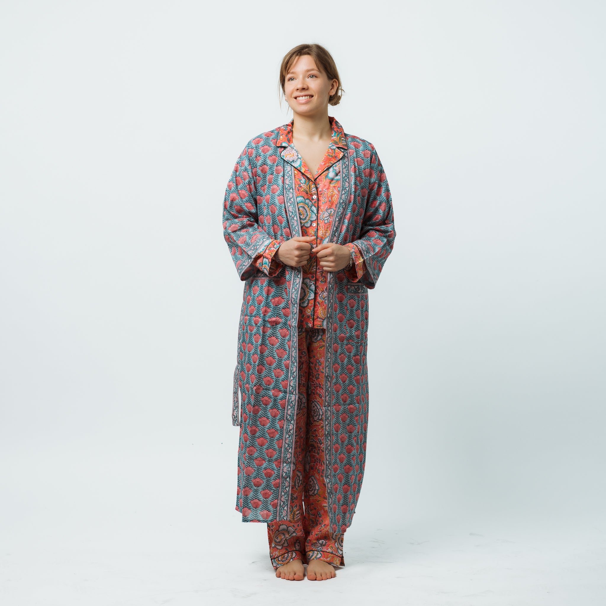 Woman wearing a patterned robe on a white background