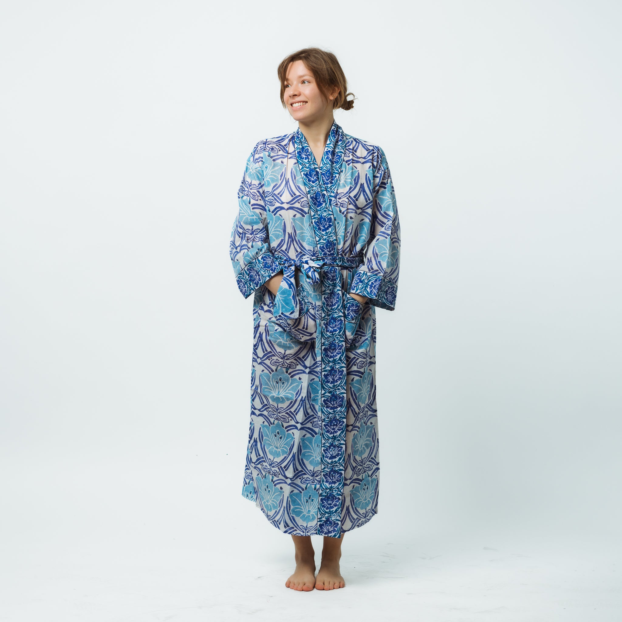 Person wearing a blue patterned robe on a white background