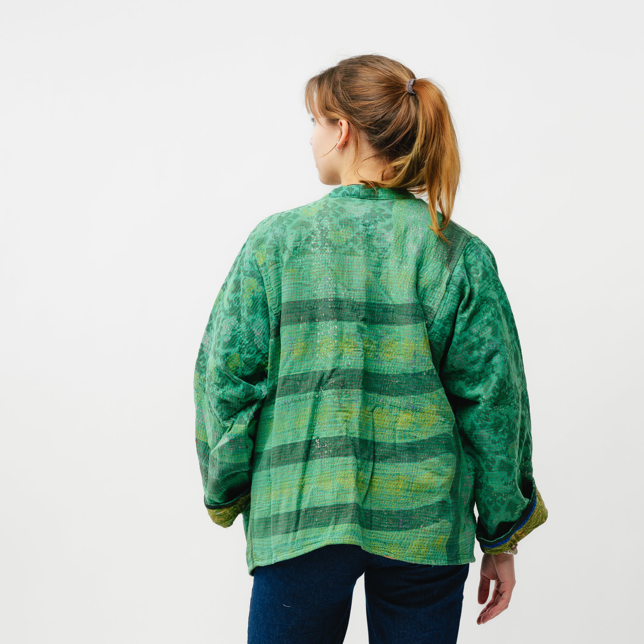 Person wearing a green plaid shirt on a white background